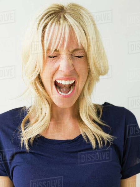 Studio Portrait Of Blonde Woman Screaming Stock Photo Dissolve
