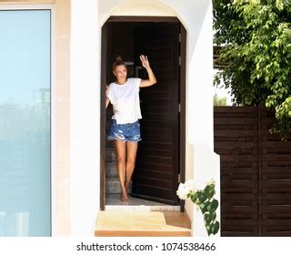 Man Opening Door Her Homeinviting Guests Stock Photo
