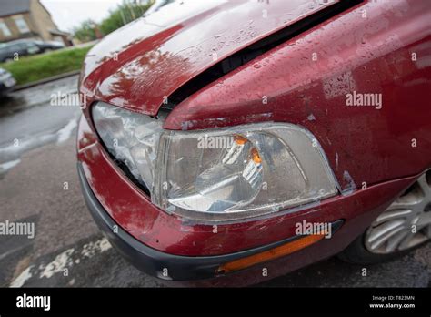 Vehicle Crash Broken Headlight And Damaged Bumper On An Old Red Car