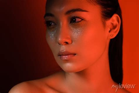 beautiful naked asian girl with silver sparkles on face in red posters for the wall posters