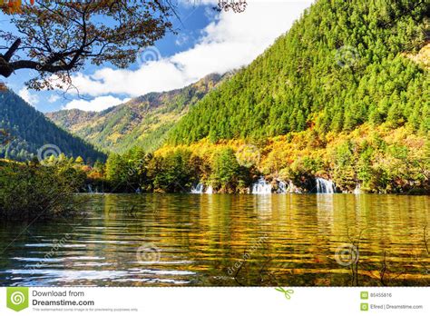 Lake With Crystal Clear Water Among Colorful Fall Woods Stock Photo