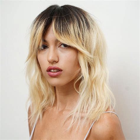 Messy Platinum Blonde Wavy Textured Lob With Fringe Curtain Bangs And