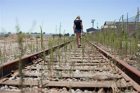 Young Girl Walking Along The Railroad Tracks By Carolyn Lagattuta