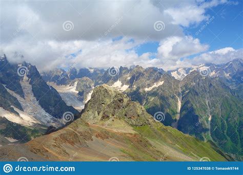 Mount Ushba Glacier Covered Partially By Clouds In Caucasus Mountains