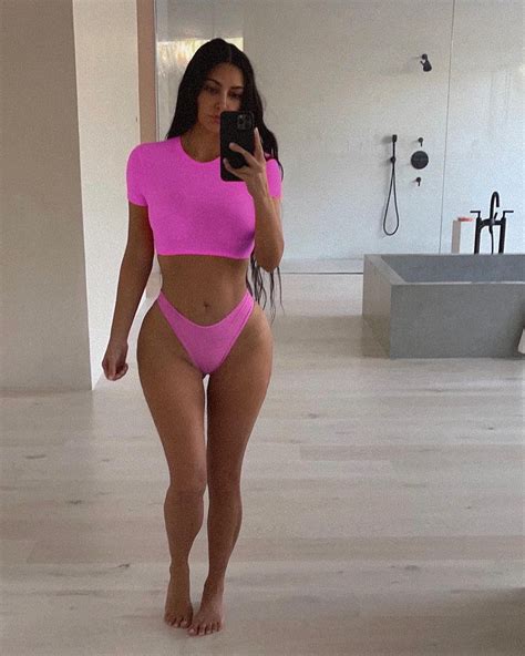 kim kardashian poses in a hot pink skims two piece