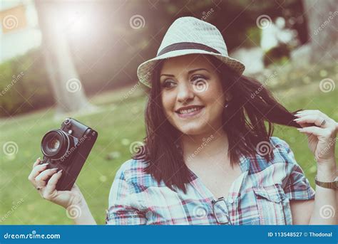 Beautiful Young Woman Taking Pictures In A Park Light Effect Stock