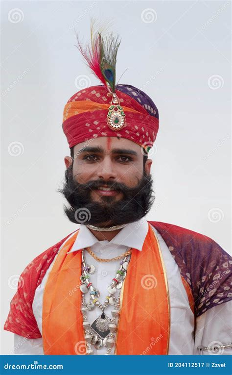 Rajasthani Handsome Man In Traditional Clothes Poses For A Photo During Camel Festival In