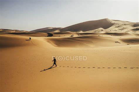 Man Walking In Sunny Sandy Desert Sahara Morocco — Beauty In Nature