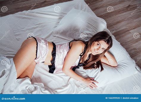 Girl In Pink Pajamas Lying On Bed Stock Photo Image Of Pillows