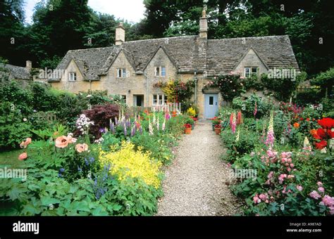 Ancient Cottages And Traditional English Cottage Gardens With Flowers