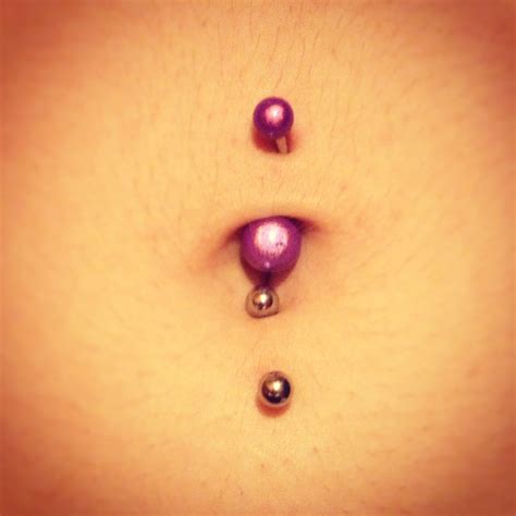 my double belly button piercing pattern tattoo bronze color belly button piercing