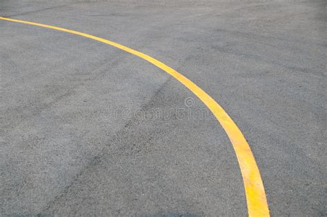 Yellow Curve Traffic Line On Road Floor Texture And Background Stock