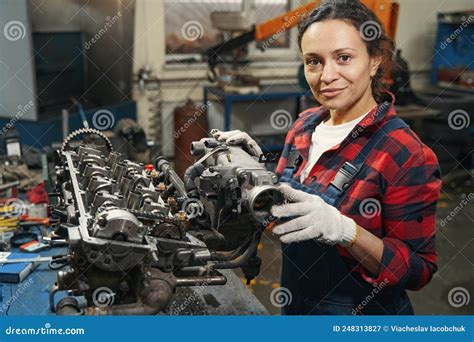 Female Auto Mechanic Fixing Car Engine In Repair Service Station Stock