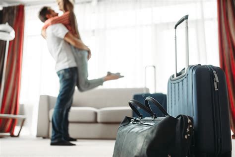 Premium Photo Suitcases Prepared For Vacation Happy Couple Hugs
