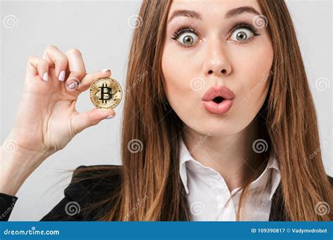 Surprised Young Woman Holding Golden Bitcoin And Looking Camera With