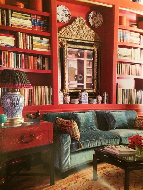 He shuddered , and felt afraid , and , going back to the couch , lay there , gazing at the picture in sickened horror. Lacquered paint, coral red built in bookshelves behind ...