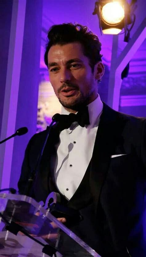 A Man In A Tuxedo Standing At A Podium