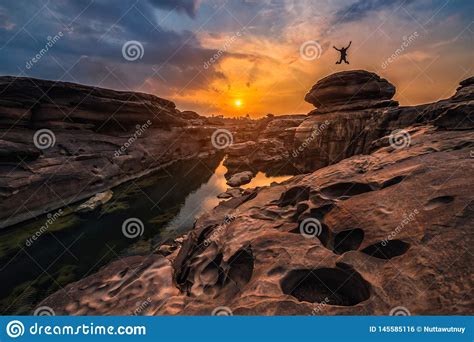 Landscape Of Sunset With Silhouette Happy Man At Sam Phan Bok In