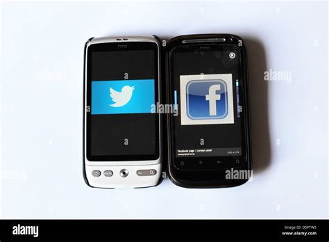 Two Mobile Phone Screens Showing Web Pages Photographed In A Studio