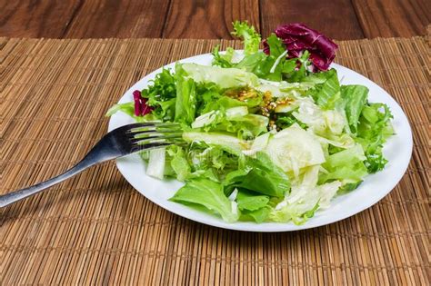 Lettuce Salad On Dish With Fork On Bamboo Table Mat Stock Photo Image