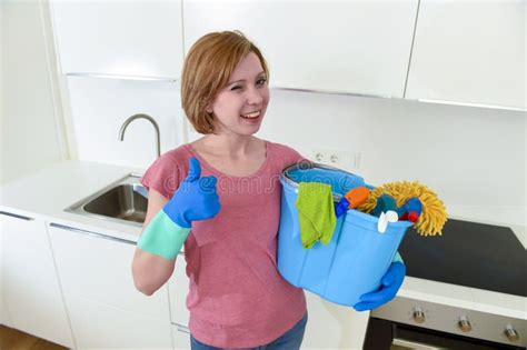 Happy Woman In Gloves Holding Cleaning Bucket With Cloth And Household