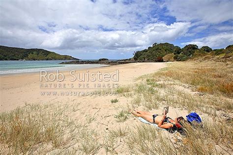 Woman Sunbathing Enjoying The Summer Sun On Maitai Matai Bay Beach