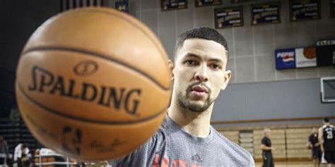 A Man Holding A Basketball In His Right Hand And Looking At The Camera