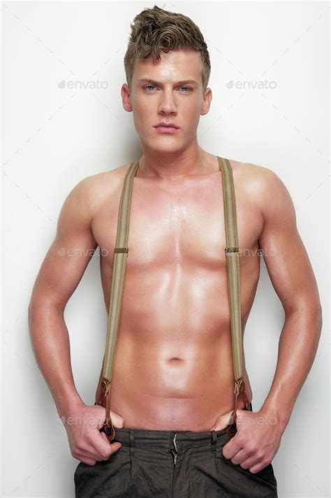 Handsome Man Undressed With Suspenders Stock Photo By Mimagephotography