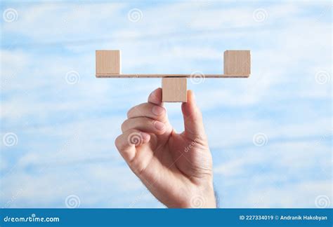 Male Hand Holding Balance Scales Made In From Wooden Cubes Stock Image