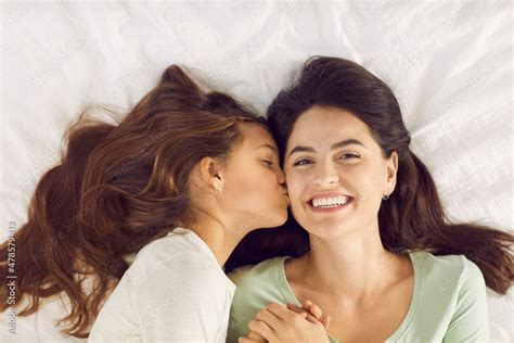 Time To Get Up Daughter Wakes Up Mum With Kiss On Morning Of Mothers