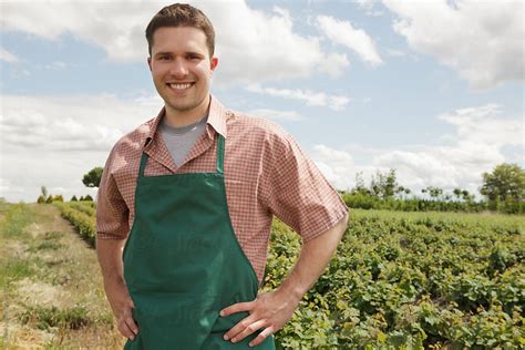 smiling farmer next to his vegetable field del colaborador de stocksy lumina stocksy