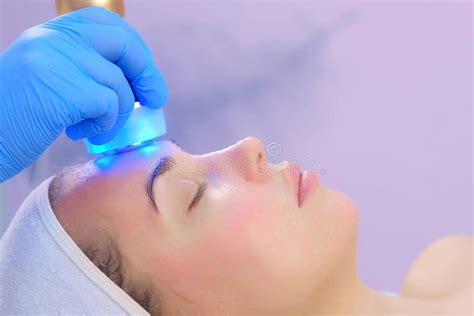 Cosmetologist Doctor Making Phonophoresis Procedure On Woman Face Side