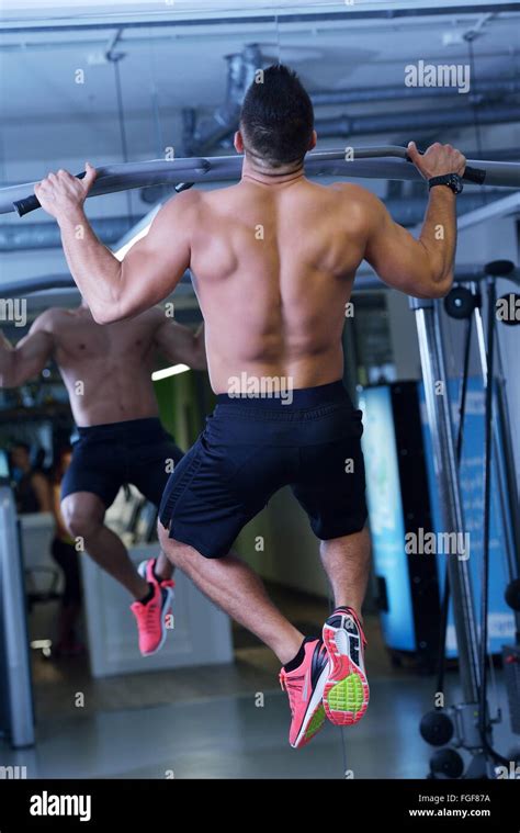 Handsome Man Exercising At The Gym Stock Photo Alamy