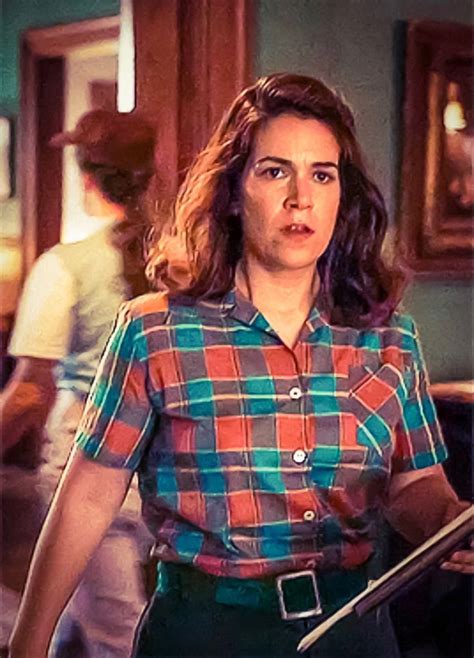 A Woman In Plaid Shirt Holding A Knife