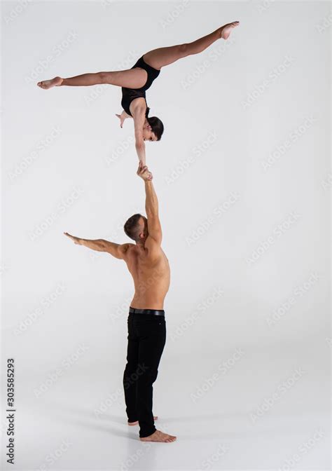 Duo Of Acrobats Showing Hand To Hand Trick Isolated On White Stock Photo Adobe Stock