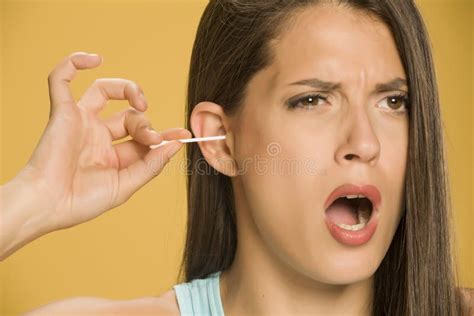 Young Woman Cleaning Her Ears With Cotton Sticks Stock Image Image Of