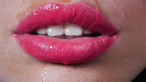 Water Drops Drip On Beautiful Female Lips Сlose Up Woman Seductively Licks Her Lips With Her