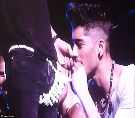 One Direction S Zayn Malik Nibbles At Harry Styles Candy Thong On Stage Daily Mail Online