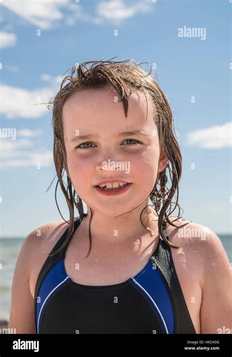 Portrait Of A Wet Young Girl In Bathing Suit At A Beach In The Summer