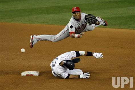 Photo Los Angeles Angels Of Anaheim Erick Aybar Throws And Leaps Over