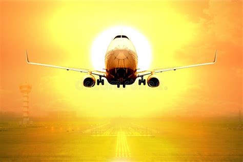 Passenger Aircraft Takeoff On Runway Of Airport In Sunset Stock Image