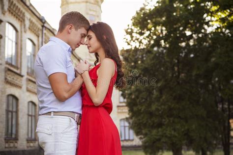 Beautiful Brunette Couple In Love Hugging On A Date In The Park Stock