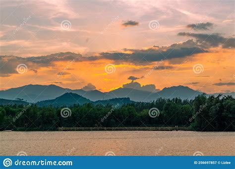 Dramatic Panorama Evening Sky And Clouds Over Mountain And Lake At