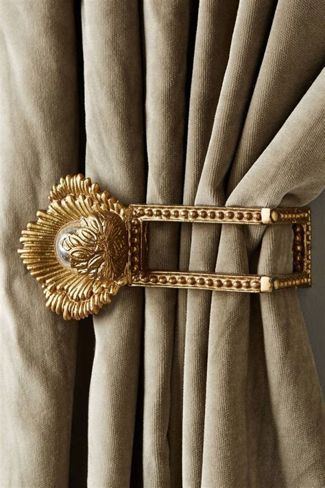An Image Of A Gold Belt On The Side Of A Curtain With Chains Attached To It