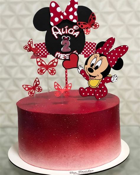 A Red Cake Topped With A Minnie Mouse Topper