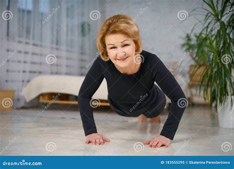 Mature Woman Doing Push Ups At Home Healthy Lifestyle Concept Stock