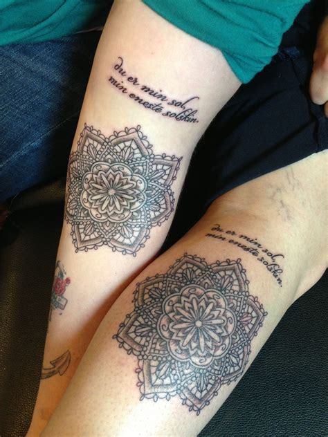 Two People With Tattoos On Their Legs Sitting Next To Each Other And One Has A Quote