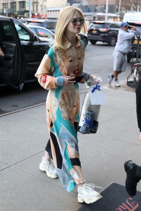 Elle Fanning Wears A Colorful Marilyn Monroe Print Dress As She Arrives At The Bowery Hotel In