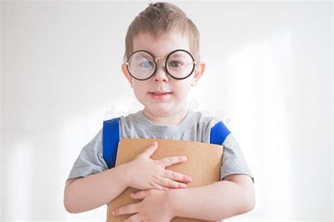 Little Toddler Boy In Glasses With Backpack And Book Preschooler In