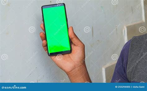 Man S Hand Shows Mobile Smartphone With Green Screen In Vertical